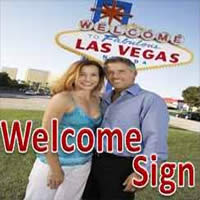 Couple in front of Welcome to Fabulous Las Vegas sign 